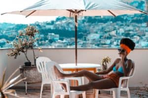 A woman relaxing under an umbrella. Learn how stress can impact your digestion.