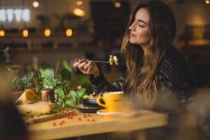 A woman enjoys a home cooked meal for dinner