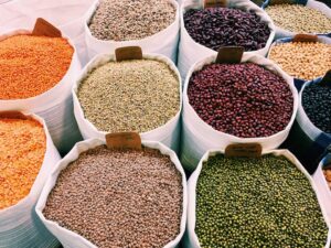 Large sacs filled with various beans and legumes