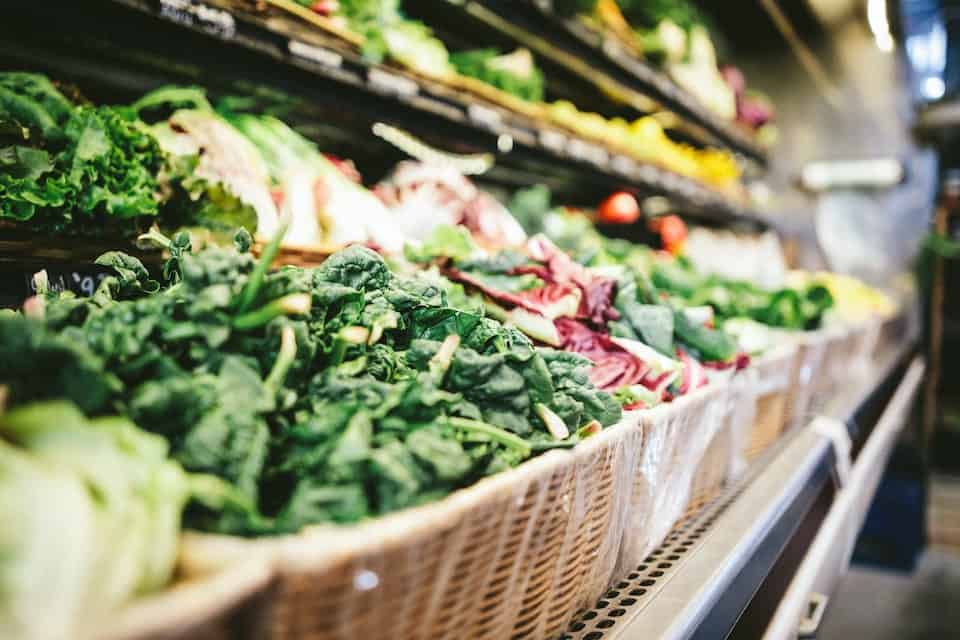 An assortment of leafy greens in the produce department of a supermarket