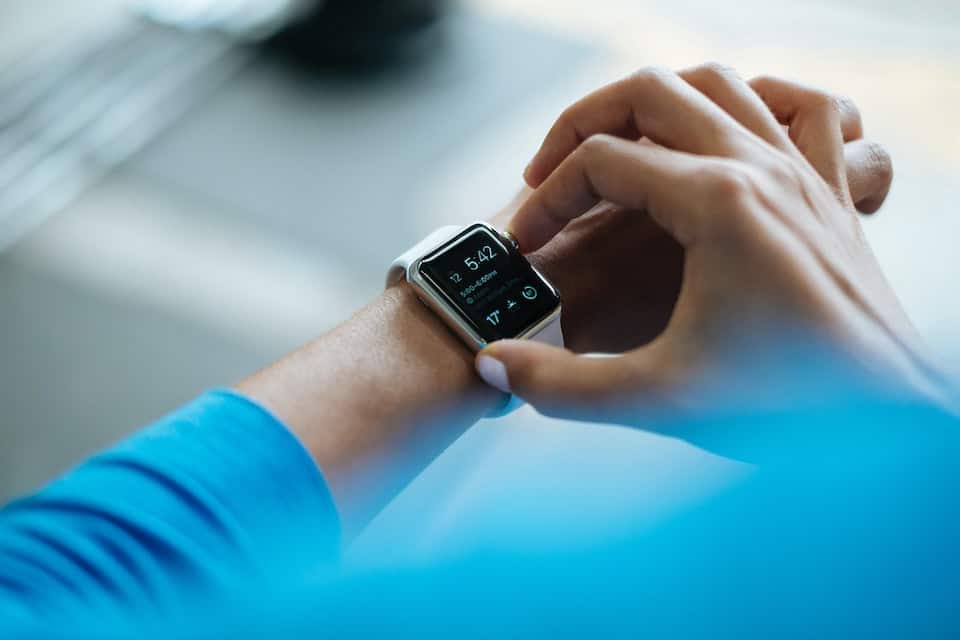 A woman checking the time on her smart watch