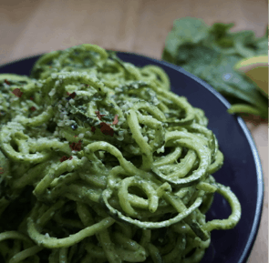 Bowl of pasta with spinach lemon help seed pesto