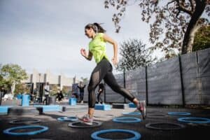 A woman runs through a park